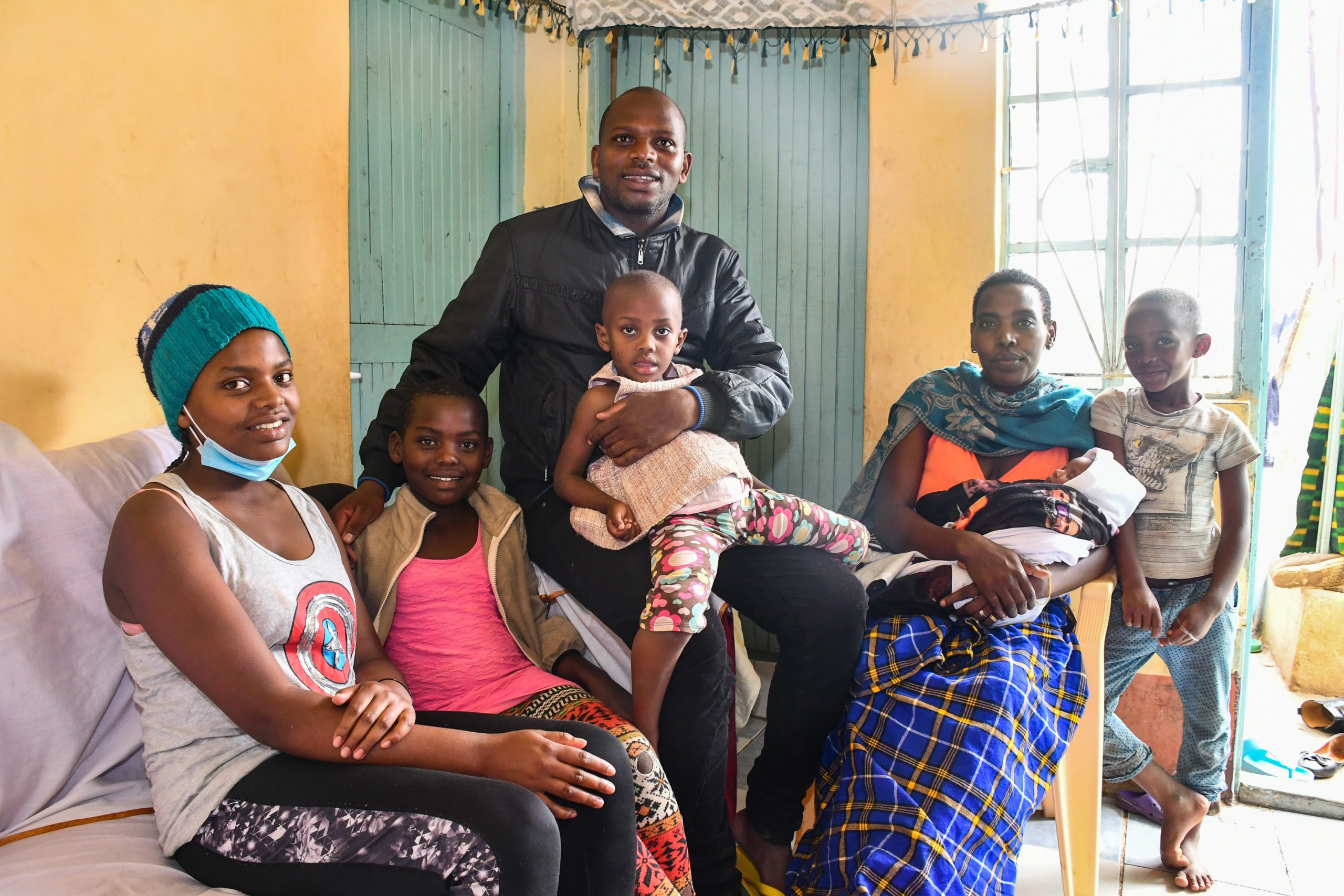 John poses for a photo with his family