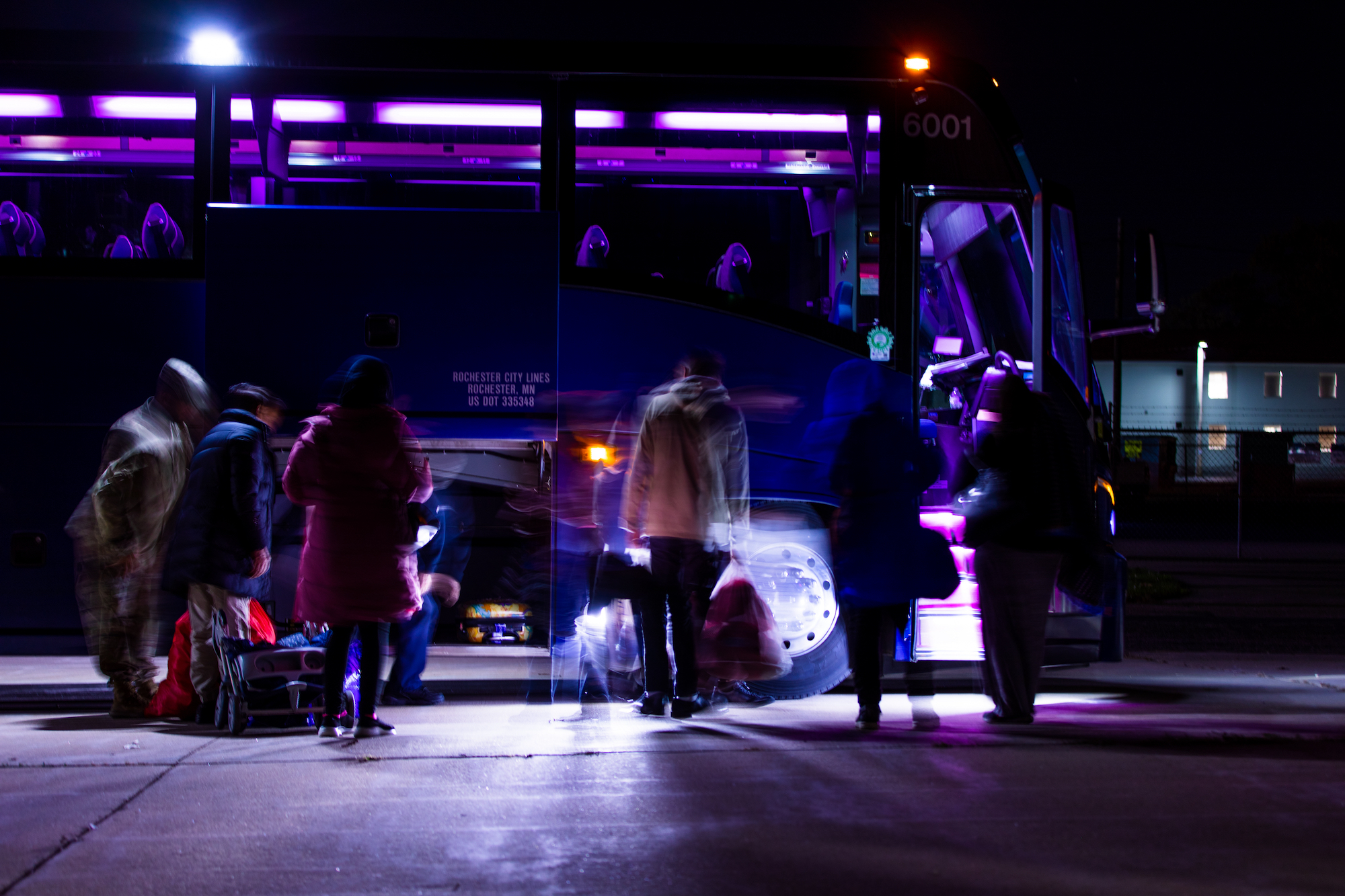 Afghan personnel moves their bags onto the bus that will transport them to the La Crosse Regional Airport in La Crosse